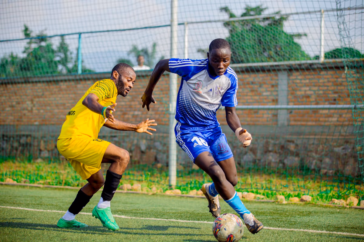 Two footballers battling fiercely for the ball during a match
