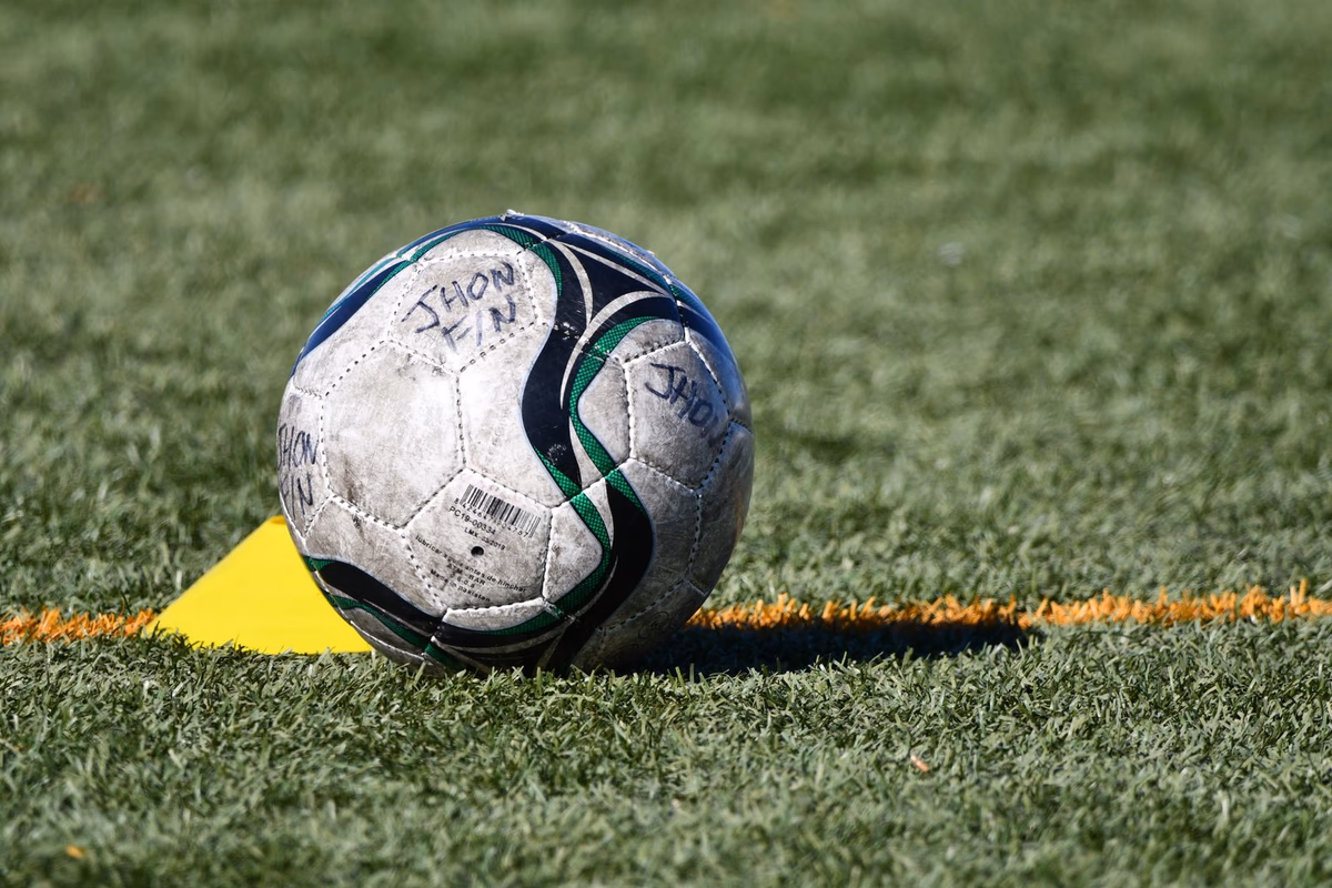 A soccer ball resting on the grass in close-up before a decisive moment
