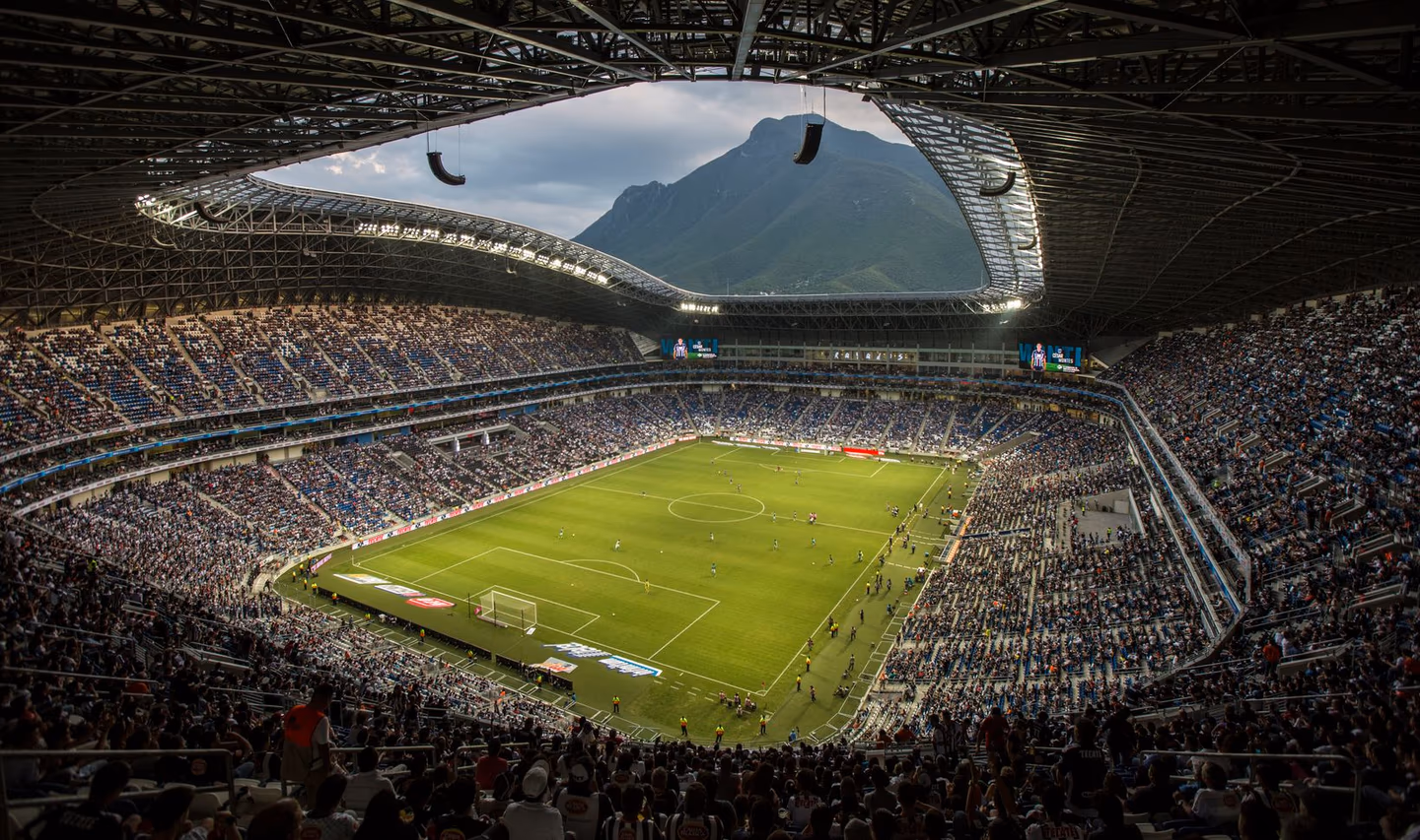 A packed Mexican football stadium filled with passionate fans on a matchday