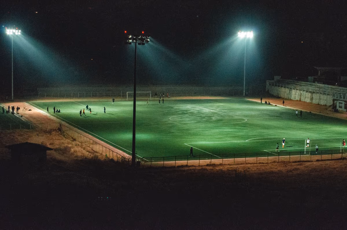 A football pitch at night under floodlights