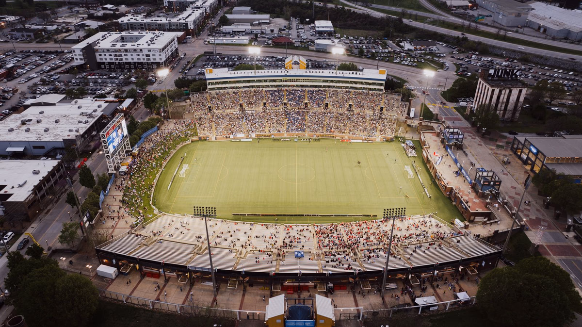 Aerial view of a large football stadium set within a North American city